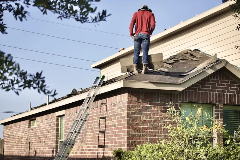 Professional roofer working on a residential roof in Valley Pond Estates